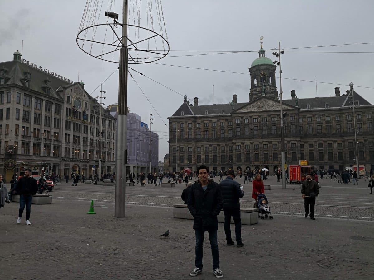 Diego Fresno standing on Dam Square in Amsterdam, with the Royal Palace behind him on an overcast November morning