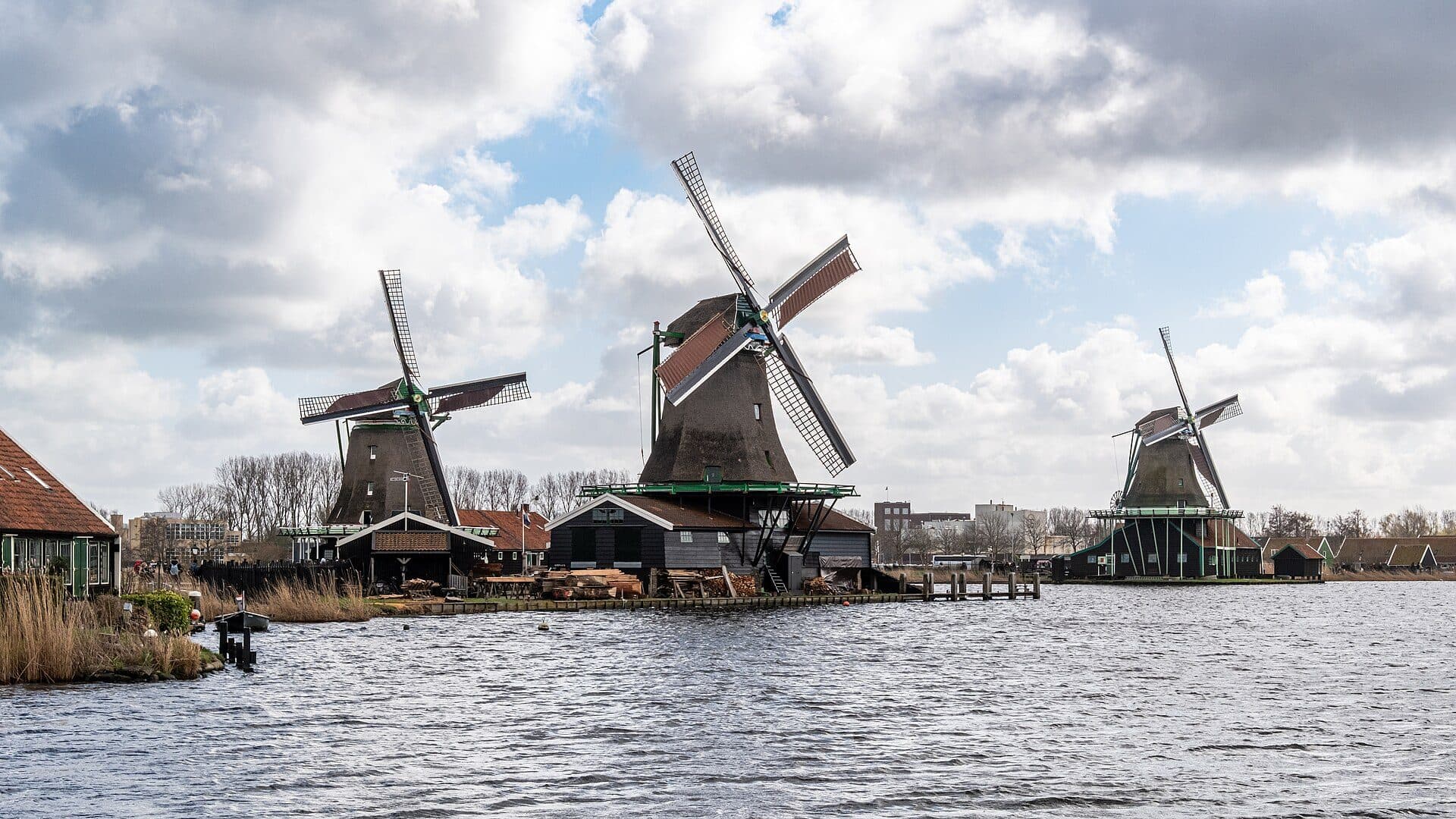 A green painted windmill at Zaanse Schans seen from the water
